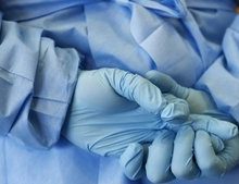 Gloved hands of army nurse seen during demonstration of an isolation chamber at Bundeswehr Clinc in Koblenz