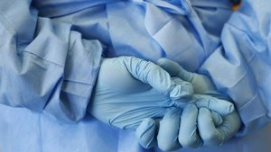 Gloved hands of army nurse seen during demonstration of an isolation chamber at Bundeswehr Clinc in Koblenz