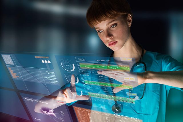 A female nurse looking at technology