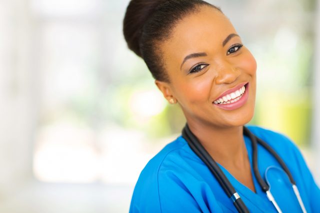 happy african nurse posing for a portrait