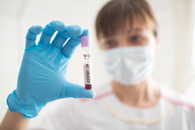 Novel Chinese Coronavirus blood test Concept. Nurse holding test tube with blood for 2019-nCoV analyzing.