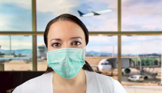 Airport Caucasian woman tourist boarding plane taking a flight in China wearing face mask. Coronavirus flu virus travel concept banner panorama.