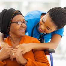 african senior patient with female nurse