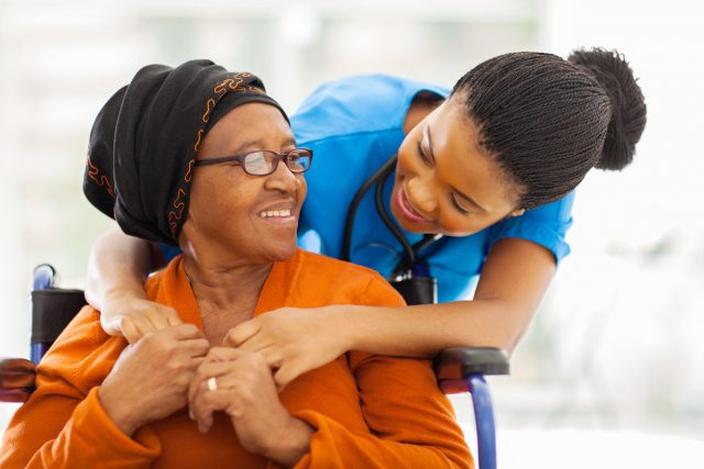 african senior patient with female nurse