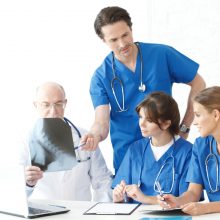Group of doctors looking at X-ray