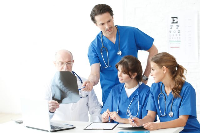 Group of doctors looking at X-ray