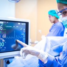 Female surgeon using monitor in operating room.