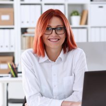 Business woman redhead office portrait sit table