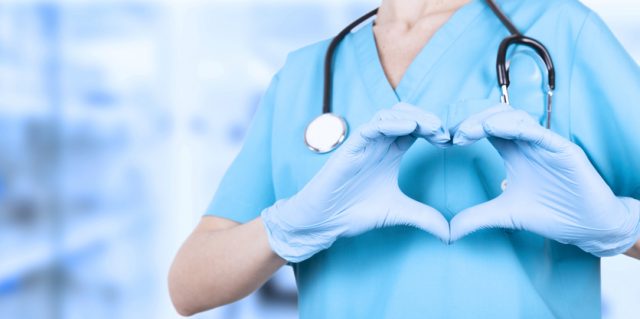 a nurse with her hands in the shape of a heart